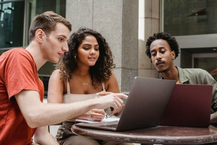 Encouraging employees for a cyber resilient workplace using CCPA - https://www.pexels.com/photo/group-of-multiethnic-coworkers-discussing-startup-project-on-laptops-together-6140676/